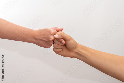 male and female hand Fist bump isolated in white ,concept of friendship and teamwork