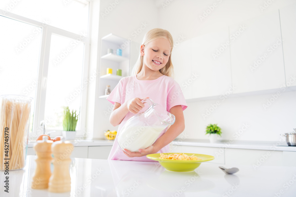 Photo of young cheerful small girl happy positive smile lunch eat crispy muesli dairy healthy food indoors