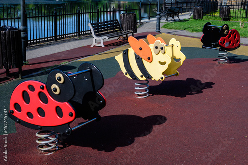 Colourful children playground with mixed plastic and metallic toys and materials in a sunny summer day in Floreasca Park in Bucharest, Romania . photo