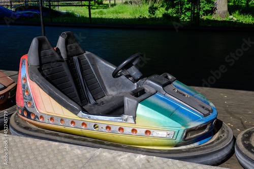 Old colorful electric bumper car in autodrom in the fairground attractions at amusement park. photo