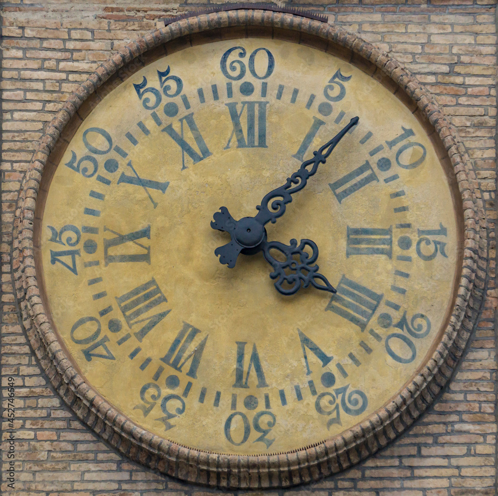 Ancient watch on the wall in PArma, Italy Ancient watch on the wall in PArma, Italy