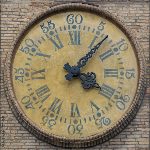 Ancient watch on the wall in PArma, Italy