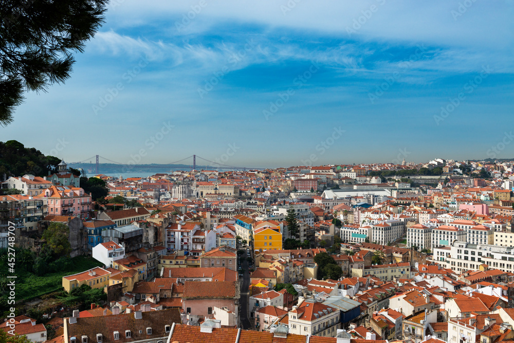 View of the downtown of the city of Lisbon from the Graca Viewpoint (Miradouro da Graca) with the Tagus River on the background, in Portugal