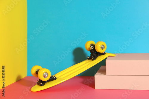 Yellow skateboard on color background. Space for text