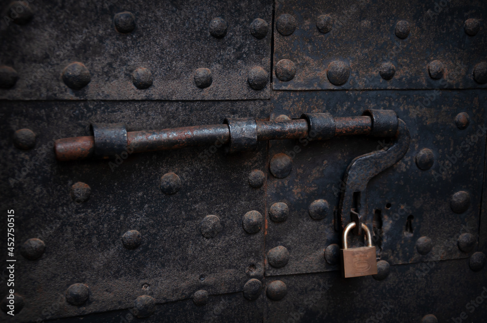 vintage bolt with a lock on a rusty iron door, Italy
