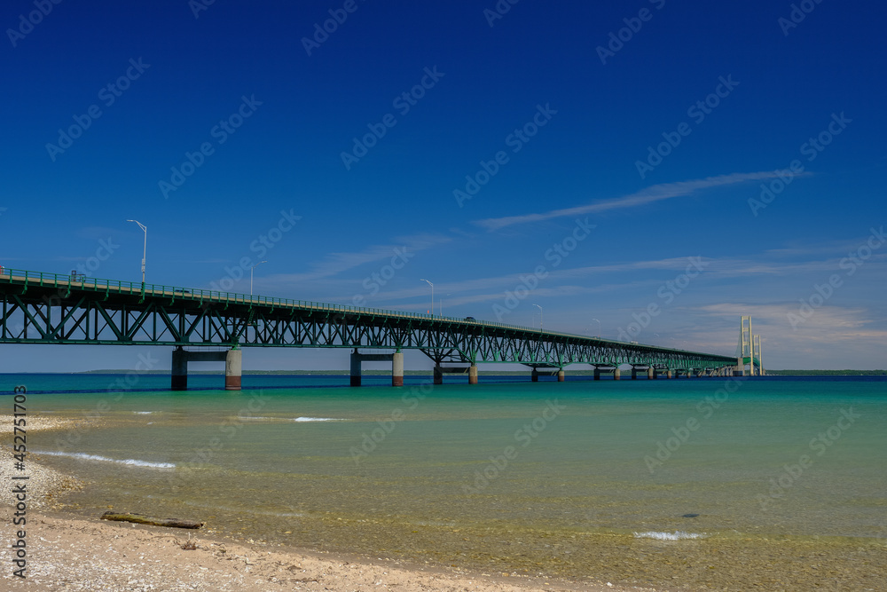 The colorful and clear waters of the straits of Mackinac and the Mackinac Bridge connecting the Upper and Lower Peninsula of Michigan