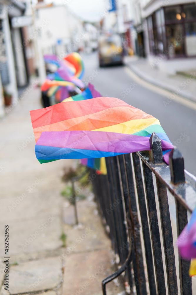 Group of LGTB flags waving on a balcony in the streets of UK.