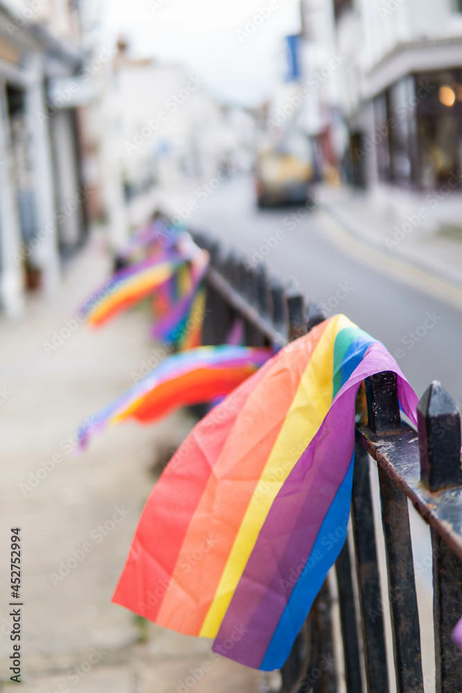 Group of LGTB flags waving on a balcony in the streets of UK.