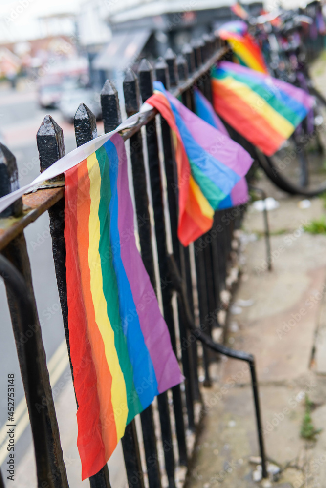 Group of LGTB flags waving on a balcony in the streets of UK.