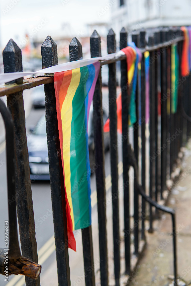 Group of LGTB flags waving on a balcony in the streets of UK.