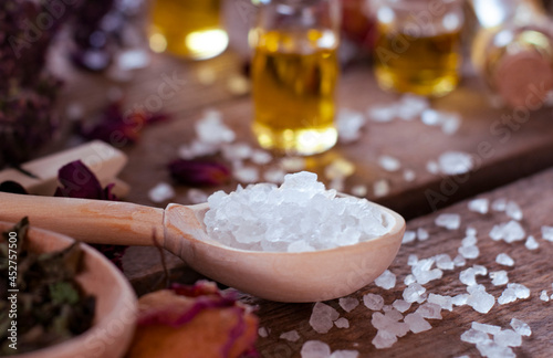 wooden spoon with white crystals and dry ingredients  on the wood table