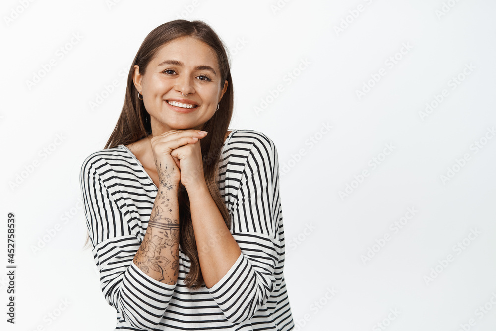 Beauty and skin care. Tender young woman showing her clean, healthy face, smiling and looking happy at camera, white background Beauty and skin care. Tender young woman showing her clean, healthy face, smiling and looking happy at camera, white background