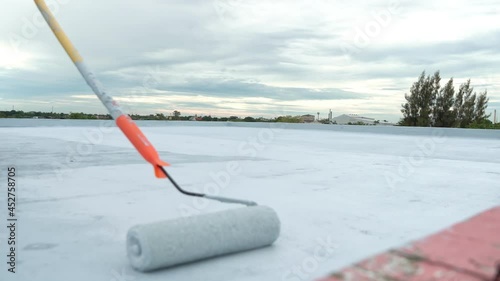 Hand painted gray flooring with paint rollers for waterproof, reinforcing net,Repairing waterproofing deck flooring.	