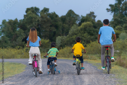 Family on cycle ride on vacation, relax in countryside