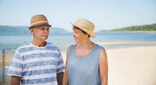 Portrait of senior couple embracing by the beach  sea on a sunny day together © ulza