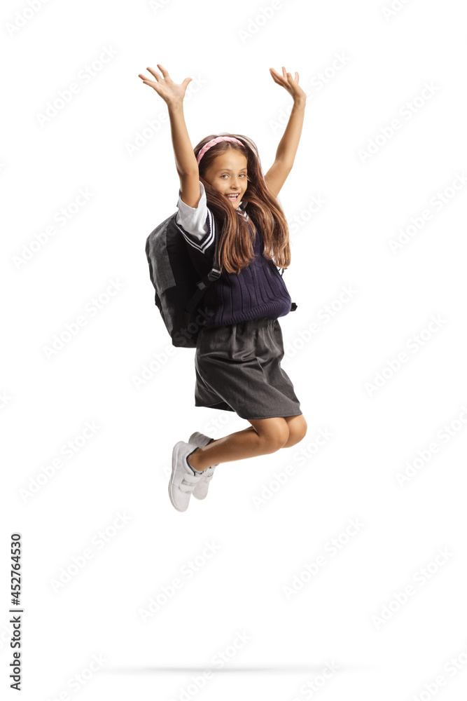 Young schoolgirl with long hair jumping and gesturing happiness Young schoolgirl with long hair jumping and gesturing happiness
