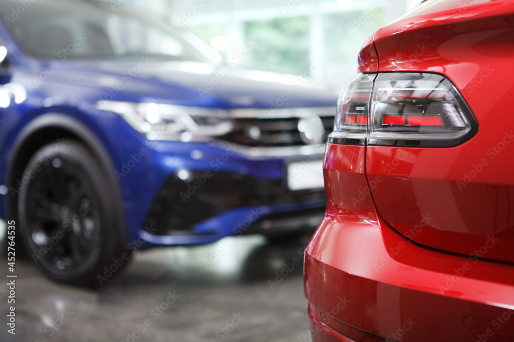 Close up of automobile lights on foreground, new auto on background Close up of automobile lights on foreground, new auto on background