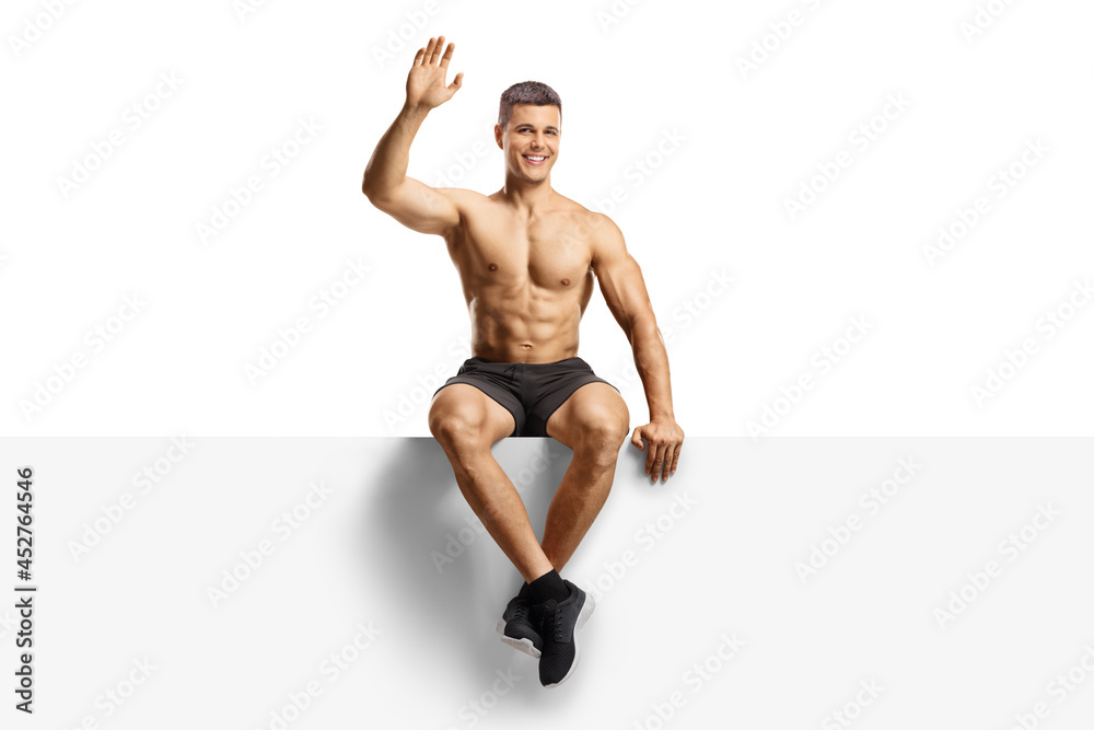 Handsome shirtless guy waving and sitting on a blank panel Stock Photo |  Adobe Stock