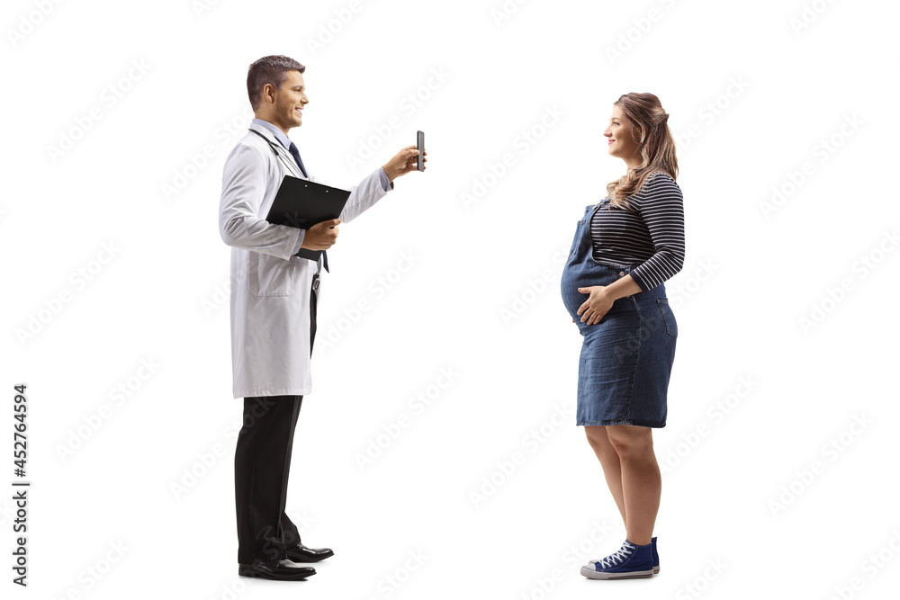 Male doctor showing a smartphone to a pregnant woman Male doctor showing a smartphone to a pregnant woman