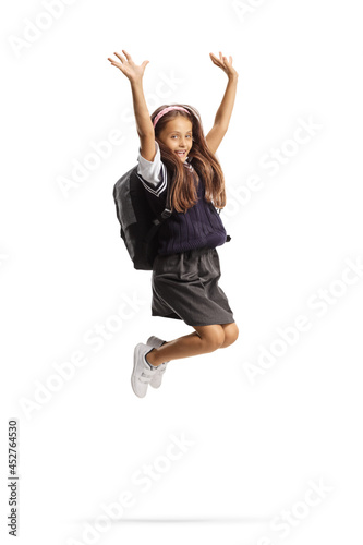 Young schoolgirl with long hair jumping and gesturing happiness