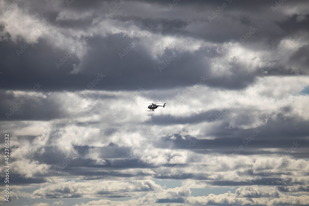 Amazing view of helicopter in cloudy sky. Sweden. 