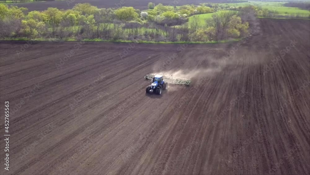 Video of big tractor with cultivator plowing on morning Video of big tractor with cultivator plowing on morning