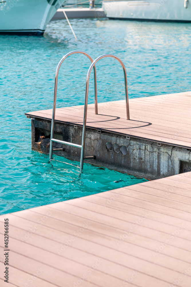 floating dock with composite deck and ladder at the marina.