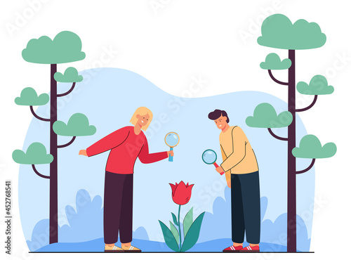 Cartoon students looking at flower through magnifying glass. Cute boy and girl watching plant, young biologists flat vector illustration. Biology, nature, outdoor activity concept for banner