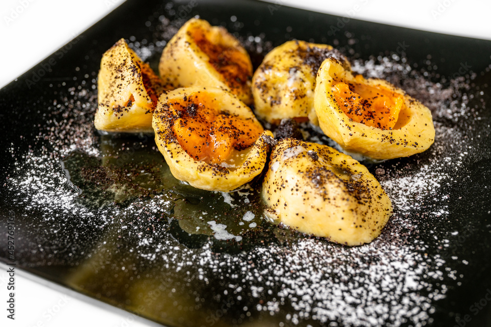 Apricot dumpling from potato dough, sprinkled with poppy seed and sugar . Apricot dumpling from potato dough, sprinkled with poppy seed and sugar .