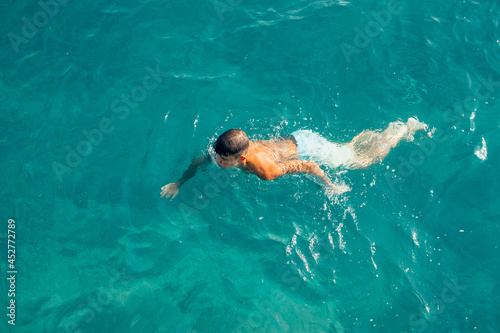 person bathing at the sea blue water