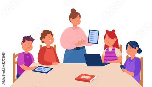 Cartoon teacher explaining task to children sitting at table. Flat vector illustration. Students learning, using gadgets, tablets and laptop in school lesson. Classroom, technology, education concept