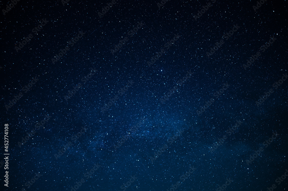 Dark blue night sky and small twinkling stars. Abstraction. Minimalism. There is no one in the photo. Astrology, Galaxy, Space. Background. Wallpaper. Texture.