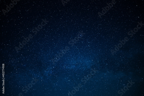 Dark blue night sky and small twinkling stars. Abstraction. Minimalism. There is no one in the photo. Astrology  Galaxy  Space. Background. Wallpaper. Texture.
