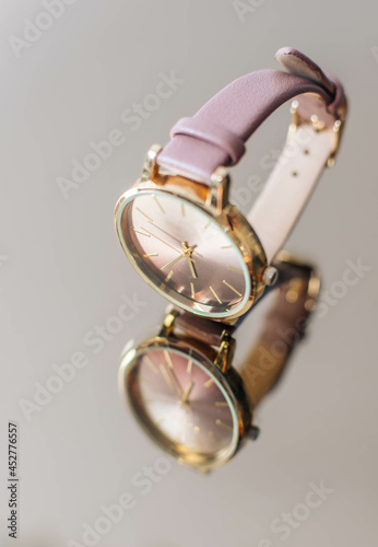 Luxury leather wristwatch or a watch isolated on mirror background with reflection