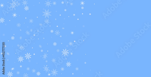 White delicate openwork snowflakes are scattered on a blue background. Festive background  postcard design  wallpaper