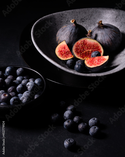 fresh figs and blueberries on a wooden board