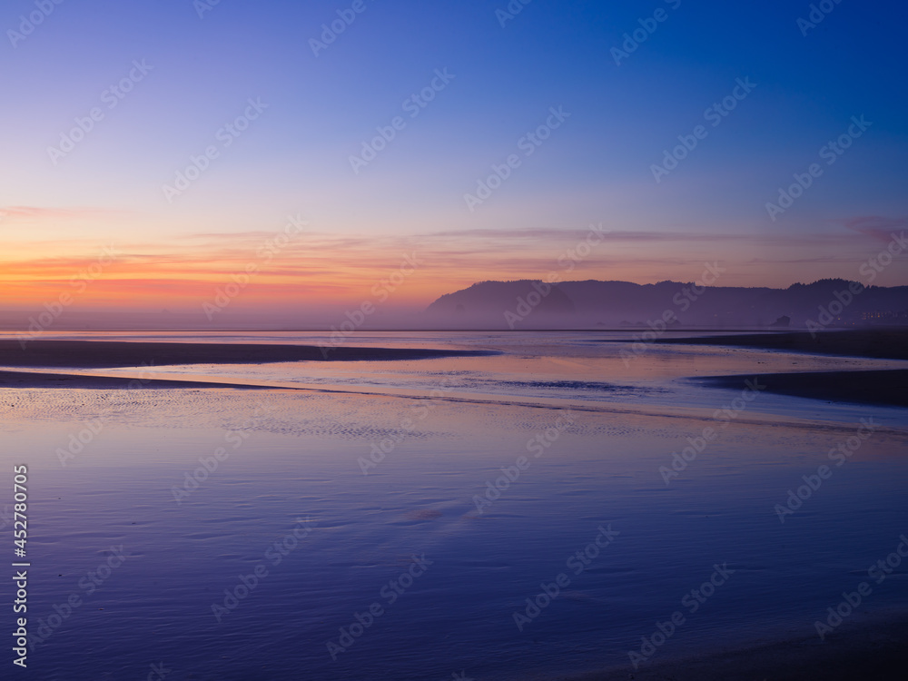 Blue ocean. Cliffs can be seen in the distance. Dust. Sunset. Peaceful calm scenes. High angle view. There are no people in the photo. There is an empty space for insertion.