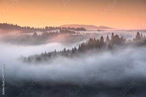 View of alpine valley covered with fog