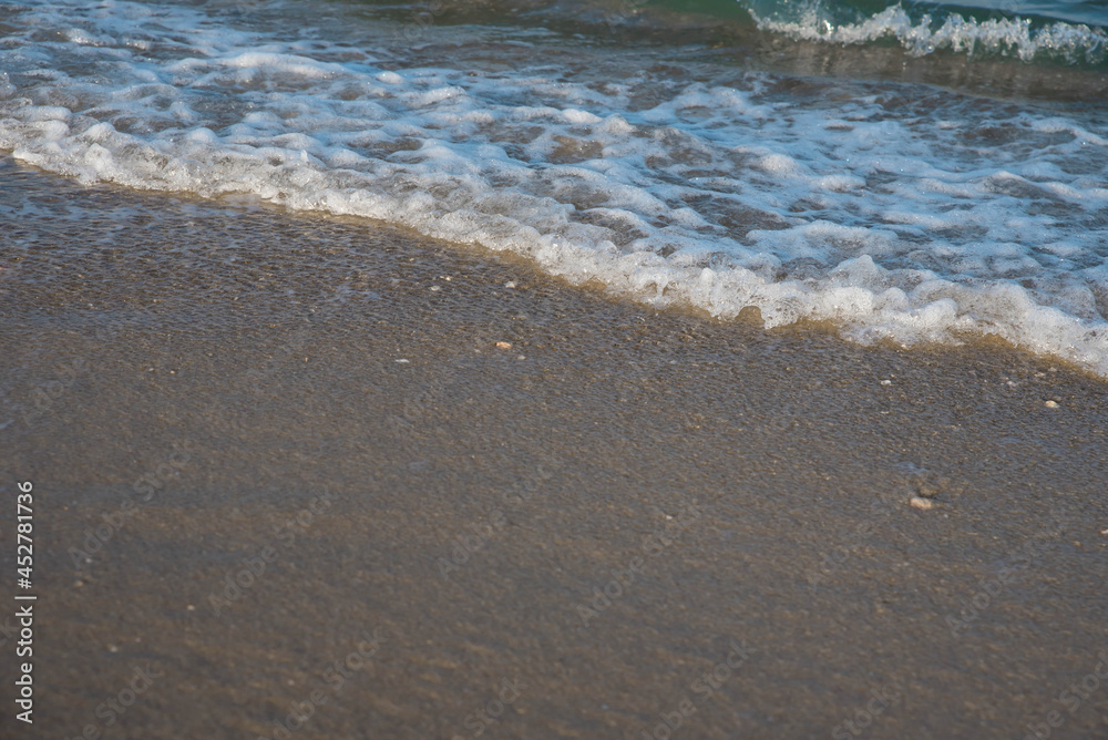 Sea or ocean tropical landscape view. Sea waves under the sun. Summer vacation and travel concept. Water wave surface. Sand beach. 