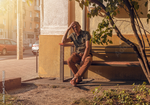 Canvastavla Man with heat stroke sitting on bench, tired of hot temperature, summer weather in city