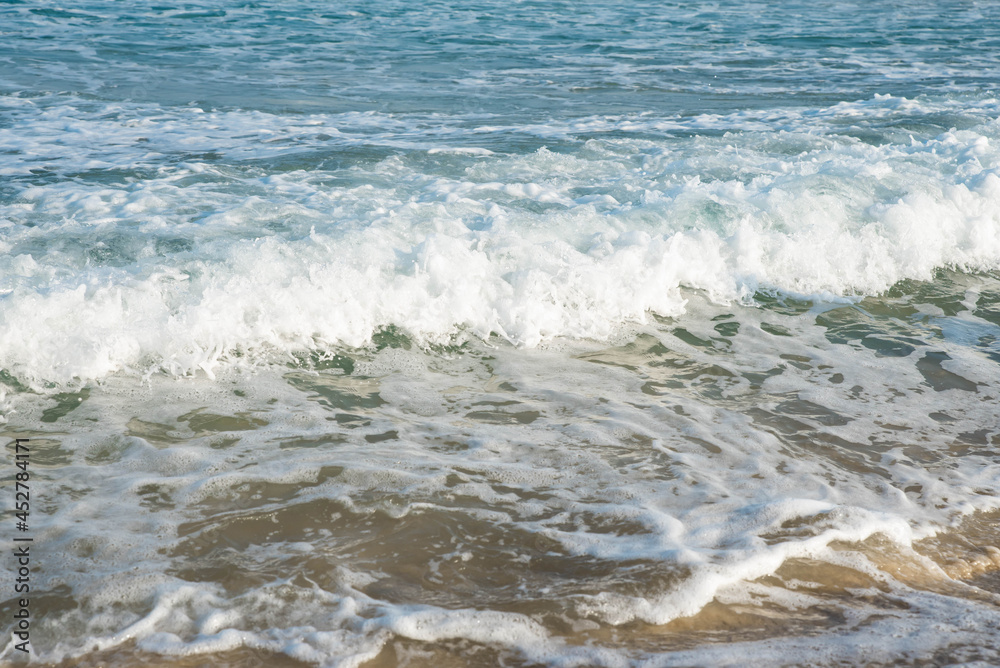 Sea or ocean tropical landscape view. Sea waves under the sun. Summer vacation and travel concept. Water wave surface. Sand beach. 