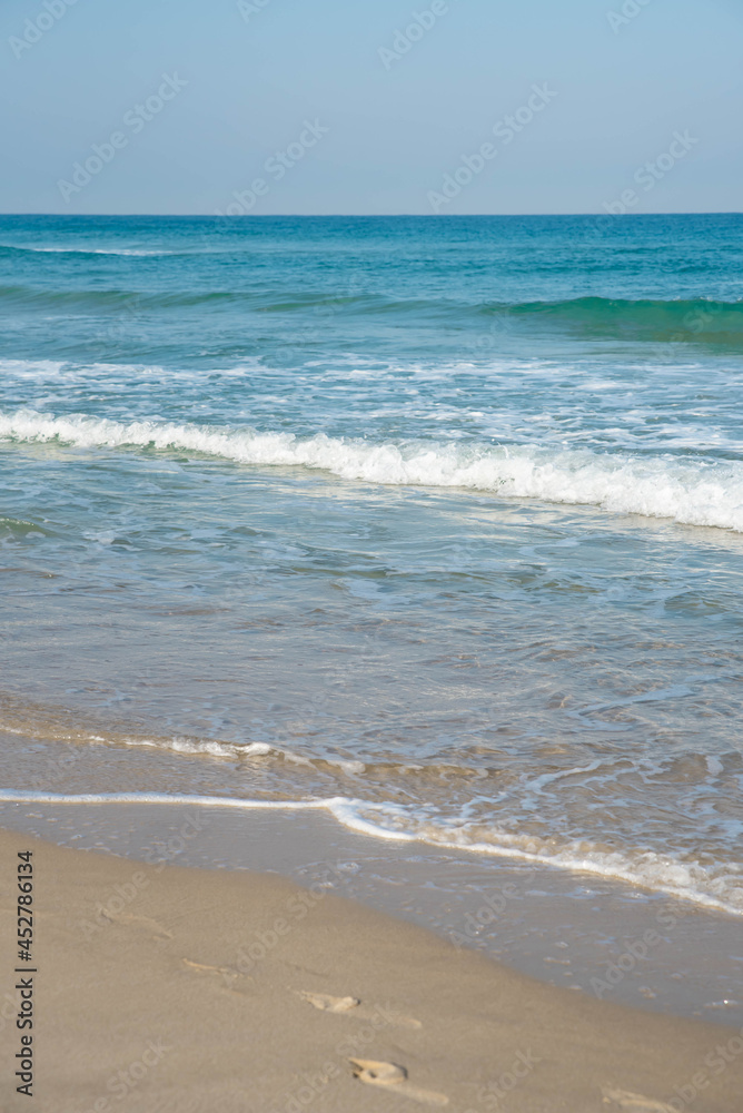 Sea or ocean tropical landscape view. Sea waves under the sun. Summer vacation and travel concept. Water wave surface. Sand beach. 