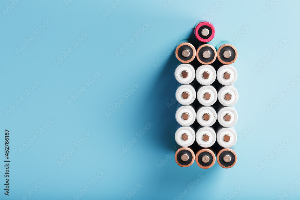 AA finger batteries in the form of a large battery on a blue background. AA finger batteries in the form of a large battery on a blue background.