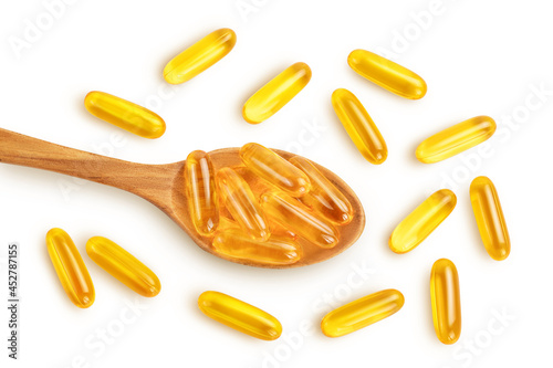 Fish oil capsules in wooden spoon isolated on white background with clipping path and full depth of field. Top view. Flat lay
