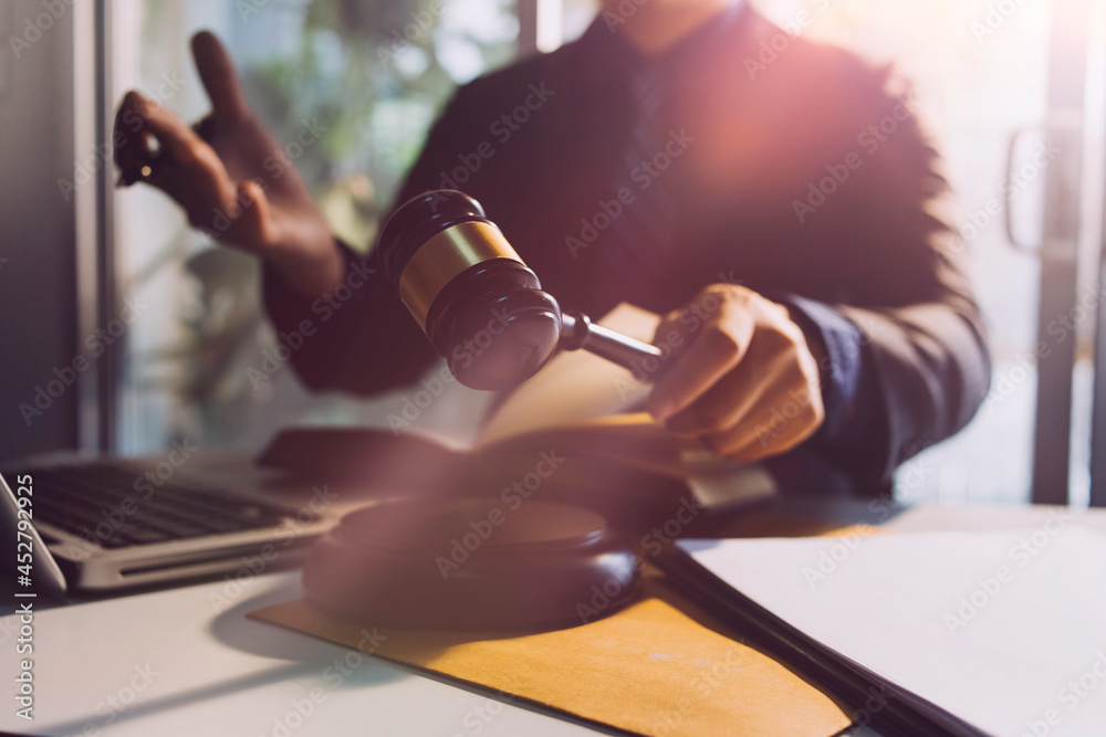 Fototapeta premium Business and lawyers discussing contract papers with brass scale on desk in office. Law, legal services, advice, justice and law concept picture with film grain effect