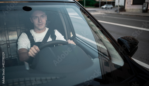 Express service a male driver in uniform delivers boxes. The employee takes the order home to the client. Courier service for the delivery of goods.