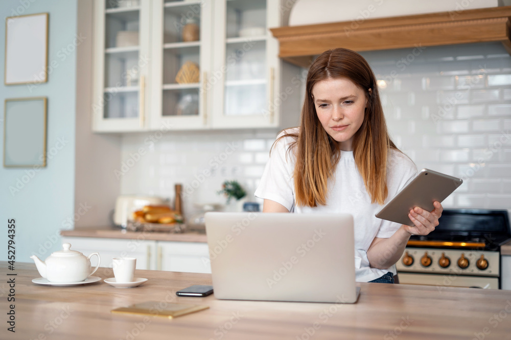 A woman sits at home and writes a message to a client by mail. He does his homework on the computer, is connected to the Internet. Student studying online through a social network. A woman sits at home and writes a message to a client by mail. He does his homework on the computer, is connected to the Internet. Student studying online through a social network.
