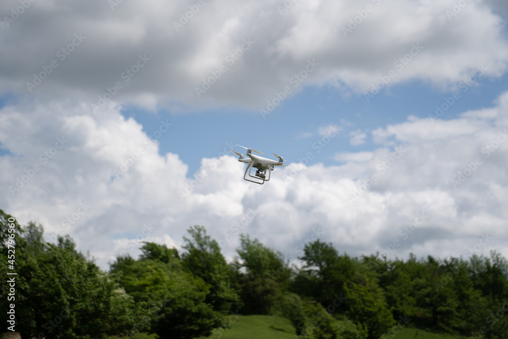 a white drone flies in the blue sky over the mountains and shoots a video. a white drone flies in the blue sky over the mountains and shoots a video.
