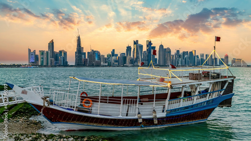 Doha, Qatar - February 2019: Doha Qatar skyline with traditional Qatari Dhow boat in the harbor
