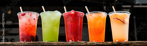 Fotografie colourful Lemonade in transparent cup, five summer lemonades